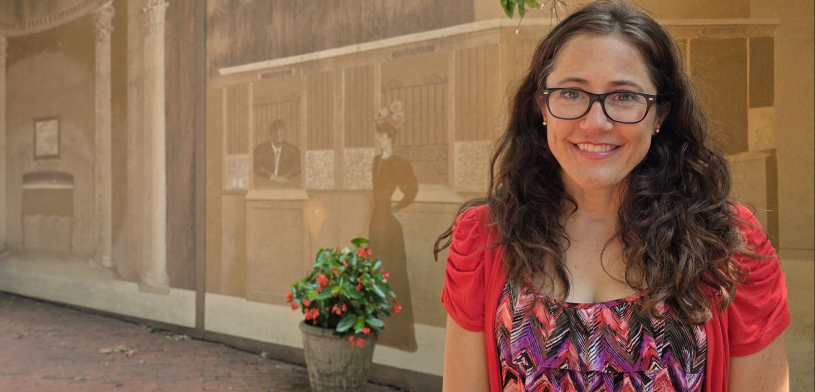 Sara Jaeger standing in front of the historic mural in Taylor Park, downtown Orange, Virginia